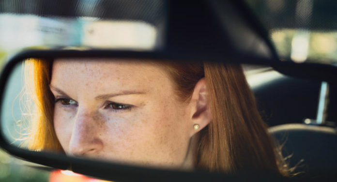 Woman Driving a Car - Reflection in the Mirror