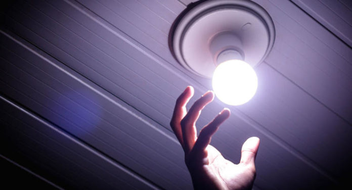 In this illustration a man changes his house light bulb
